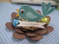 a blue bird sitting on top of a nest filled with eggs