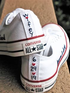 a pair of white converse shoes with the words converse all - star written on them