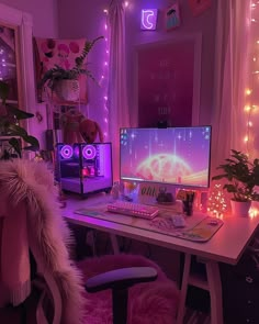 a computer desk with two monitors on it and some lights in the room behind it