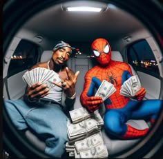 two men sitting in the back of a car with money