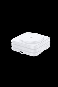 a stack of white plates sitting on top of each other in front of a black background