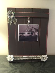 an old photo frame is decorated with flowers