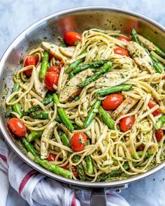 pasta with asparagus, tomatoes and chicken in a pan