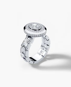 a white gold ring with diamonds on the top and bottom, set in 18k white gold