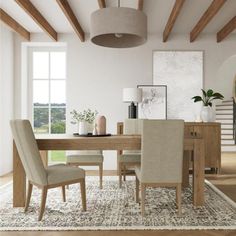 a dining room table with beige chairs and an area rug on top of the floor