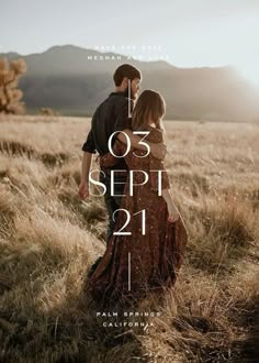 a man and woman standing next to each other in a field