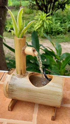 a bamboo planter with water coming out of it