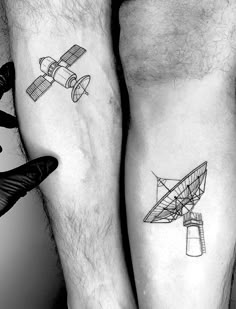 two people with tattoos on their legs and one has a small plane tattoo on his leg