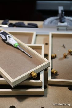 a pair of scissors sitting on top of wooden frames