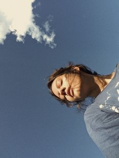 a man standing in front of a blue sky with a frisbee flying through the air