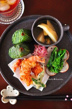 a plate with some food on it and chopsticks next to the plate,