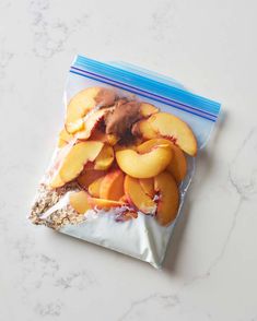 a bag filled with sliced peaches sitting on top of a counter