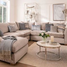 a living room filled with lots of furniture and decor on top of a hard wood floor