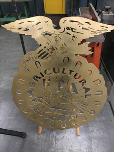 a metal sign that is on top of a stand in a room with other items