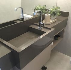 a bathroom with a sink, mirror and toilet paper dispenser in it