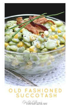 a bowl filled with corn and bacon on top of a table