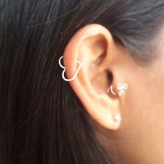 a close up of a person with ear piercings