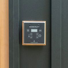 a black door with a clock on the front and side panel that says homecraft