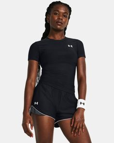 a woman wearing black shorts and a t - shirt with white trims on it