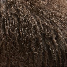 the back of a sheep's fur with lots of curly brown hair on it