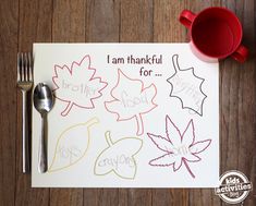 a paper with writing on it sitting next to a fork and knife, spoon and cup