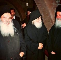 three men with long white beards standing next to each other