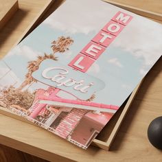 a hotel sign on top of a desk next to a computer mouse