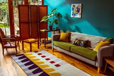 a living room with blue walls and wooden floors