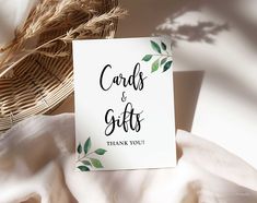 a card that says cards and gifts on it next to a wicker basket with leaves