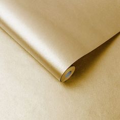 a close up view of a plain gold colored sheet of paper with an oval hole in the middle