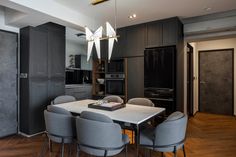 a dining room table surrounded by gray chairs