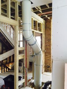 a large pipe in the middle of a room under construction