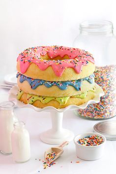 a cake with sprinkles and frosting on it sitting on a table