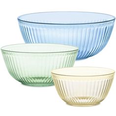 three different colored glass bowls sitting next to each other