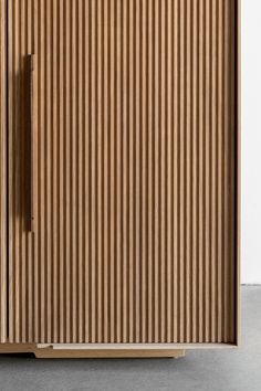 a wooden cabinet with vertical stripes on the front and back doors, made out of plywood