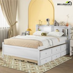 a white bed with drawers underneath it in a bedroom