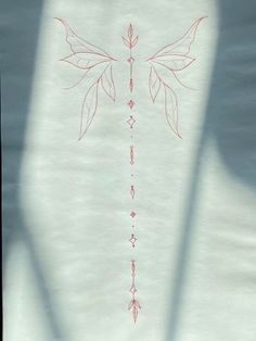 the back side of a white sheet with red lines on it and an arrow drawn in the middle