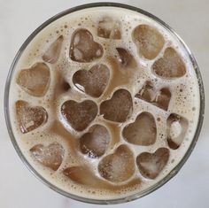 a glass filled with liquid and lots of hearts