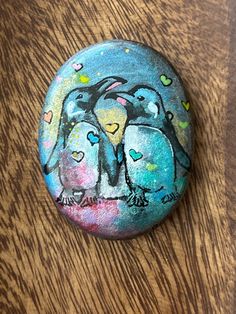 a painted rock sitting on top of a wooden table