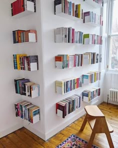 the bookshelf is filled with many different colored books