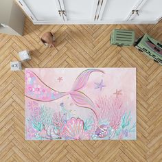 an aerial view of a living room with a mermaid rug