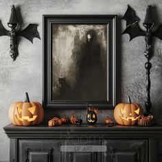 a mantle with two pumpkins on it in front of a painting and three bats