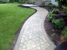 a brick walkway in front of a house