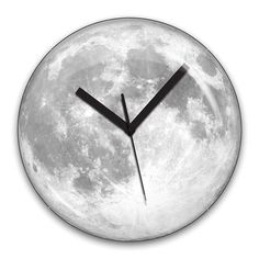 a clock with the moon in the background