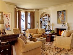 a living room filled with furniture and a fire place in the middle of a room