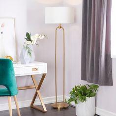 a living room with two green chairs and a white table