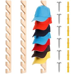 several hats are hanging from hooks on the clothes pegs next to some screws