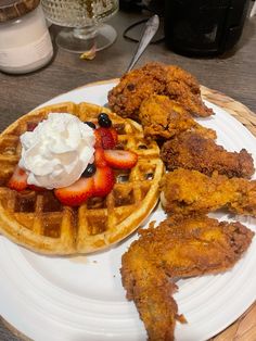 fried chicken and waffles on a plate with whipped cream