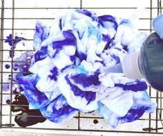 a blue and white tie dye ball sitting on top of a wire rack