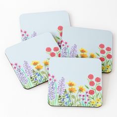 four coasters with flowers painted on them